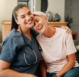 Laughing elder woman and female nurse