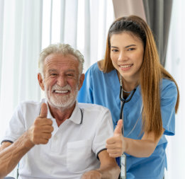 Elder man and female nurse thumbs up