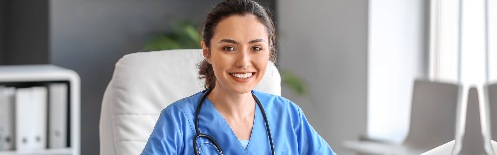 nurse smiling and looking at the camera